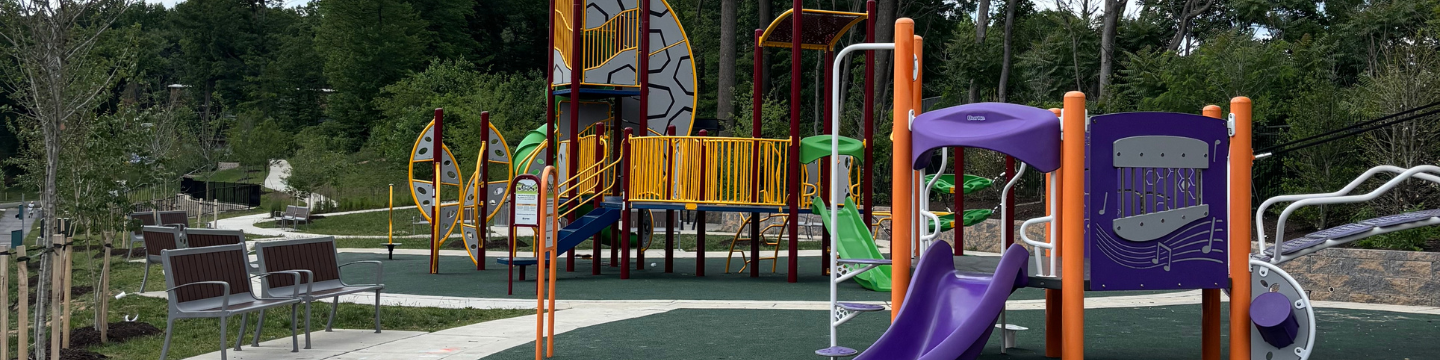 Playground equipment, walking paths, and trees at the park on Carnaby Street