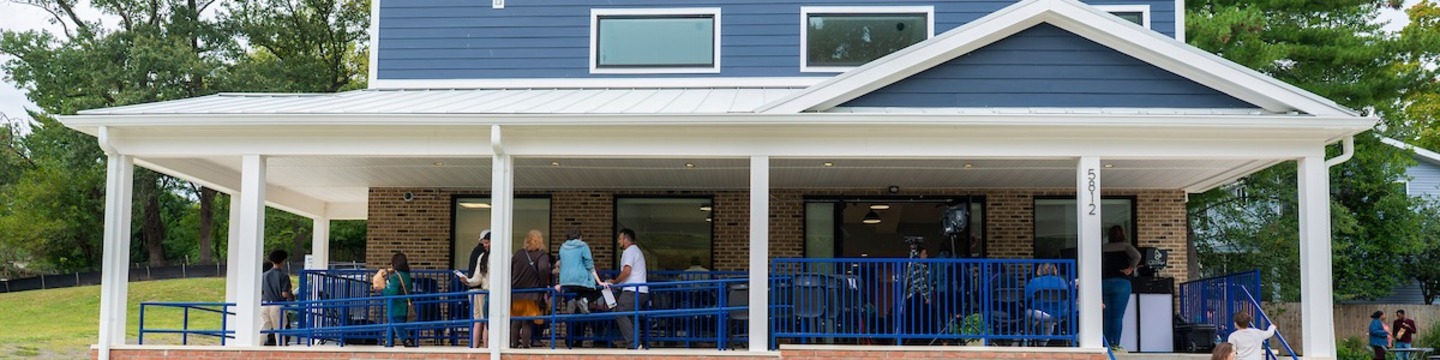 Front facade of the Hyattsville Teen Center, a blue building with white trim and a deep front porch