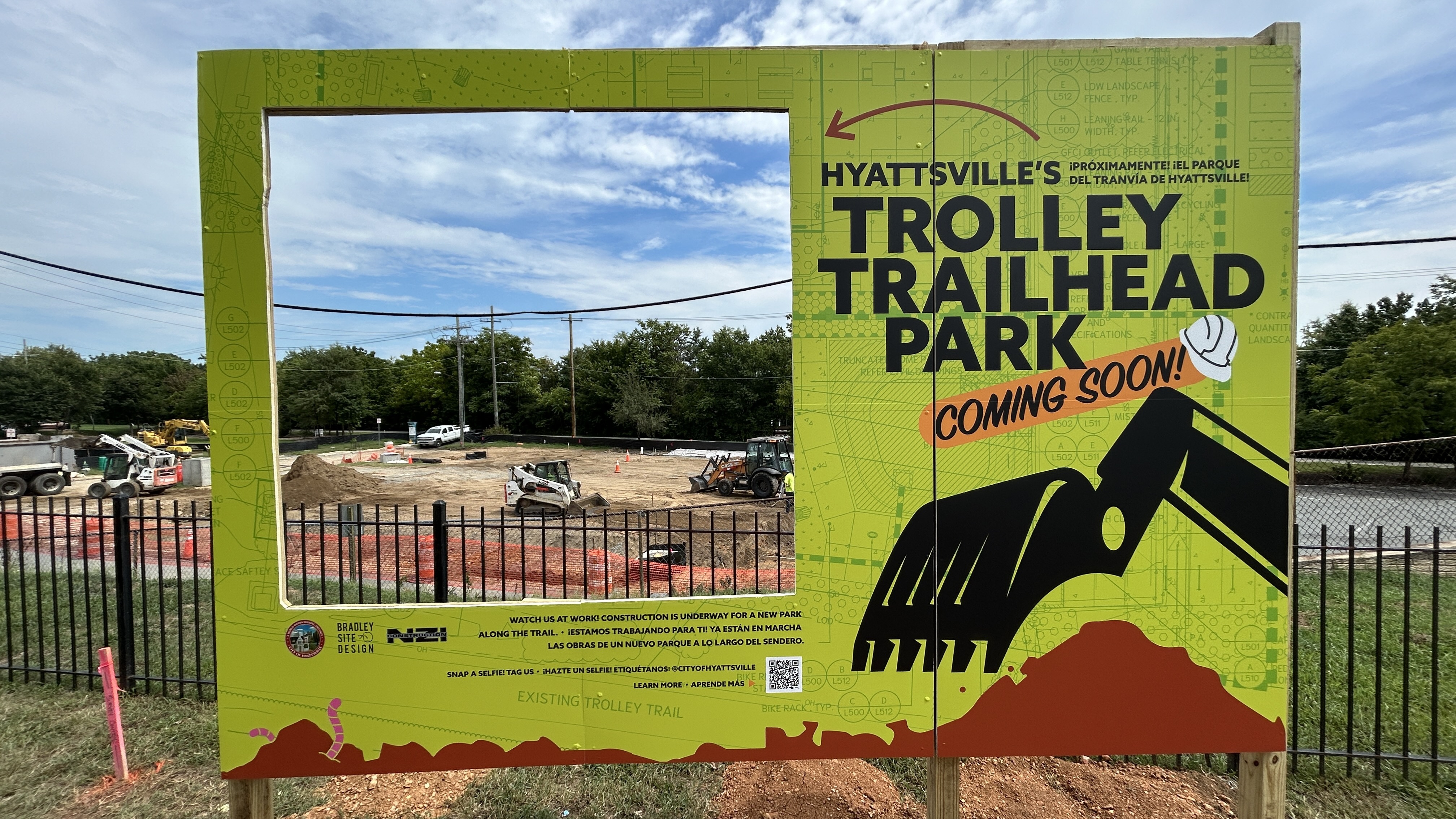 Viewing frame overlooking the construction of the spot, with the large words "Hyattsville's Trolley Trailhead Park, Coming Soon"